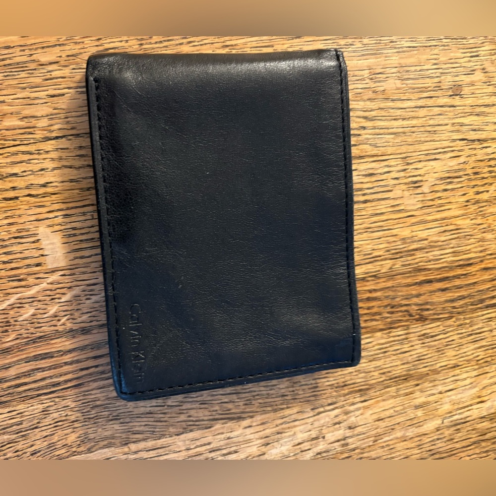 Calvin Klein black leather wallet. 4 CC slots, 2 side slots & 1 bill slot